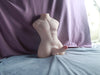 A man's body with a large silicone dildo